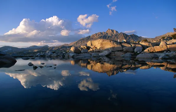 Picture the sky, clouds, sunset, mountains, lake, reflection, stones, rocks