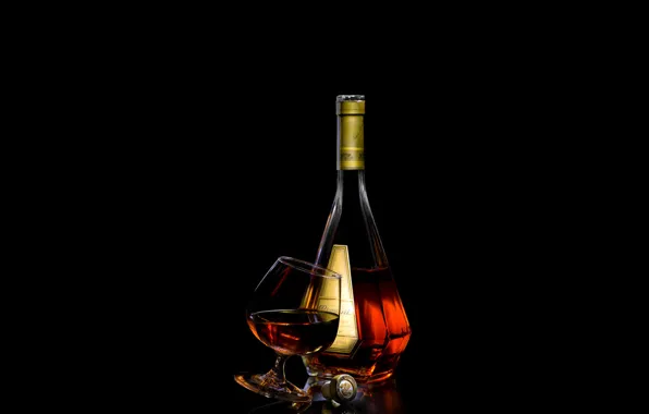 Picture glass, bottle, tube, black background, cognac