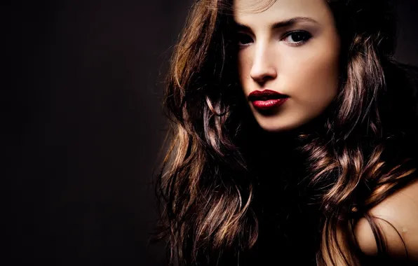 Picture the dark background, lips, brown hair