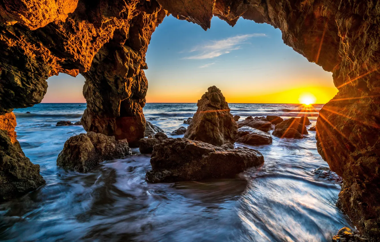 Photo wallpaper sea, the sky, stones, rocks, dawn, shore, horizon, USA, the rays of the sun, Malibu